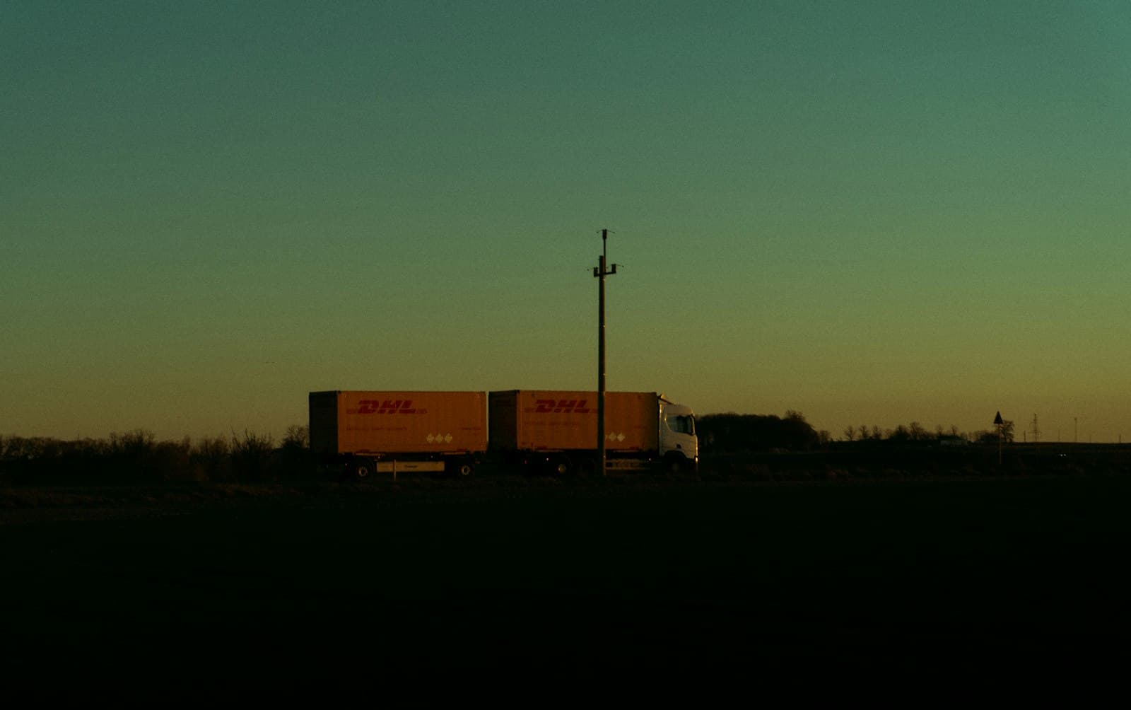 Semi-truck silhouetted at twilight